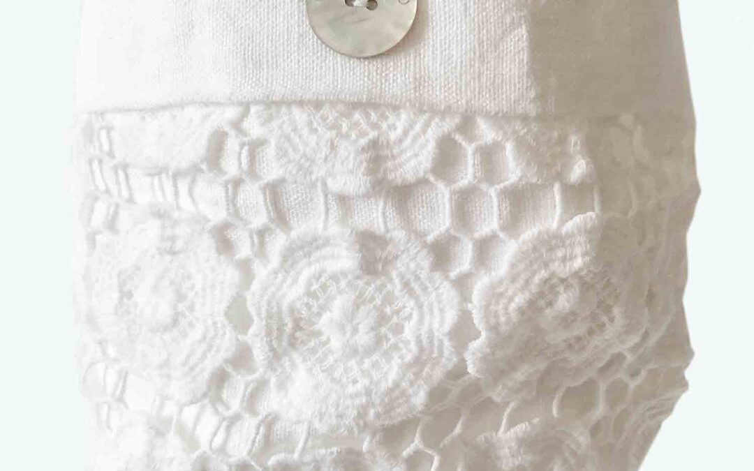 The-Whisper-Gallery-Washed-lime-white-linen-basket,-hand-finished-natural-mother-of-pearl-buttons-in-the-Renaissance-town-of-Carpi,-south-of-Verona-&-North-of-Florence